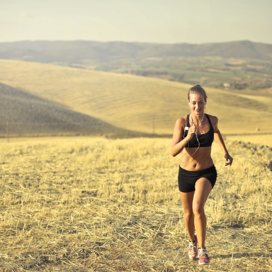 Woman running in a golden field